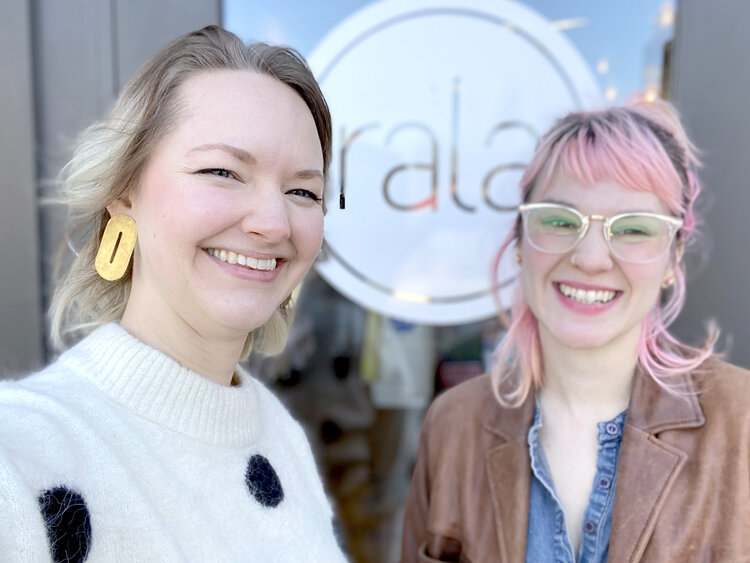 Alaina and Shelby of Cold Gold smile next to the front doors of Rala 