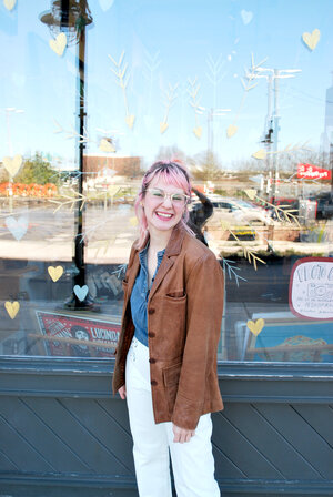 Shelby of Cold Gold stands smiling in front of the Rala storefront 