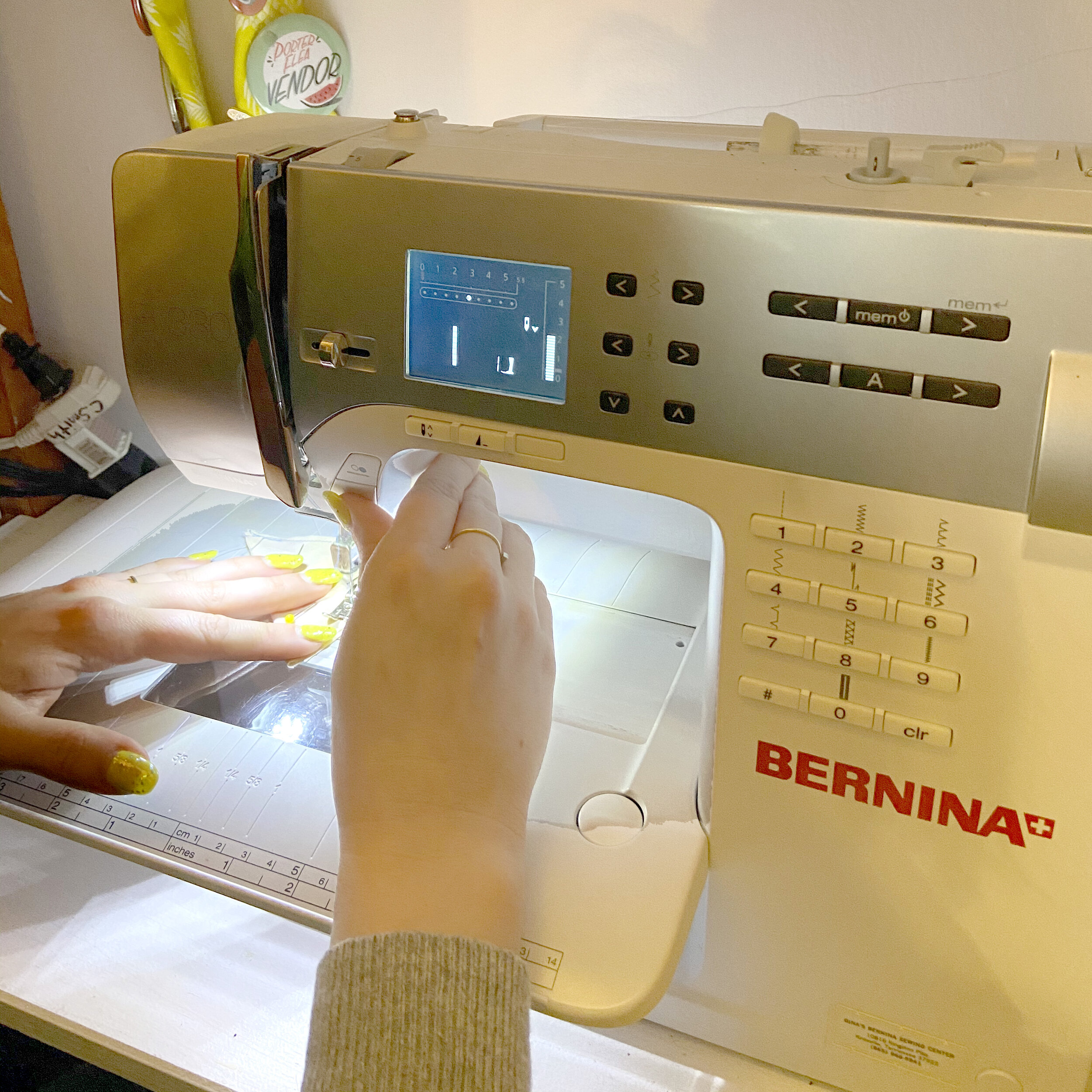 Alaina’s hands stitching cat toy together on sewing machine
