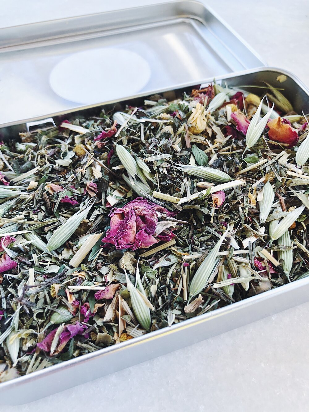 Dried herbs and flowers prepared on a tray for Flora Wellness “Relax Mom Tea“  photo credit Flora Wellness