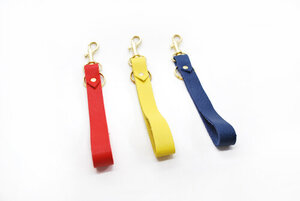 Red Poppy, Chartreuse Yellow, Navy Blue, leather keychain wrist straps displayed against a white background. 