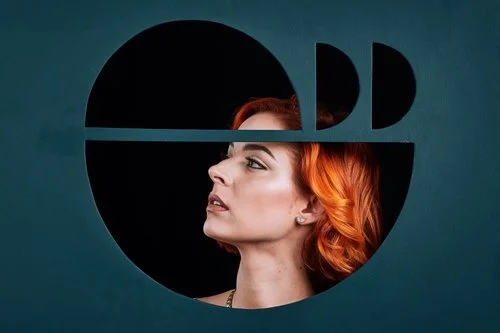 A red headed model wears the aqua marble geometric half moon stud earrings.