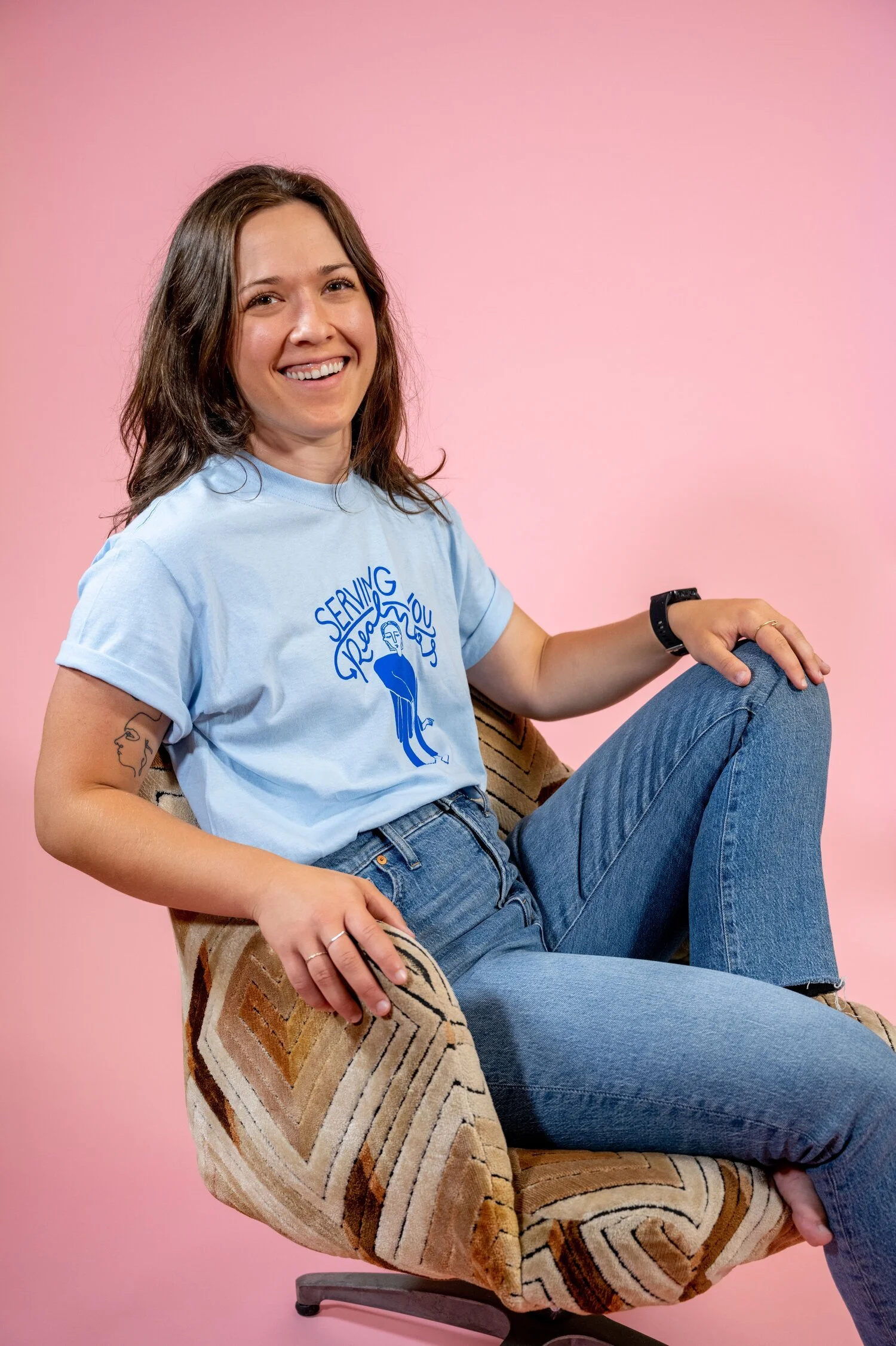 Paris Woodhull models her own “serving you realness“ tee in blue from her 2020 Playground Collection.
