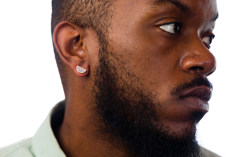 a man wears the amethyst half moon stud earrings