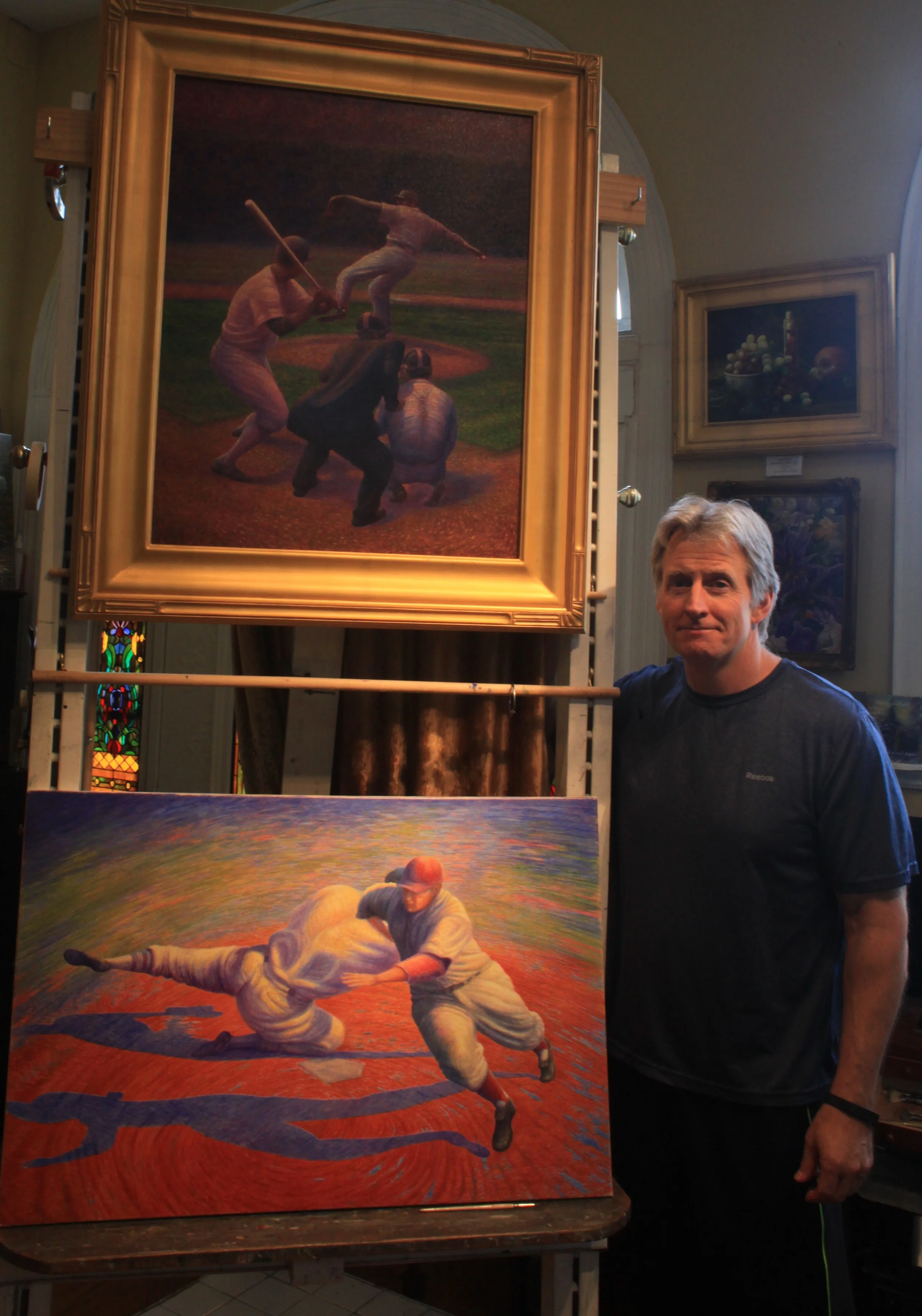 Florence Artist Keith Klein with his two paintings in the exhibit. (Photo by Mike Rutledge)