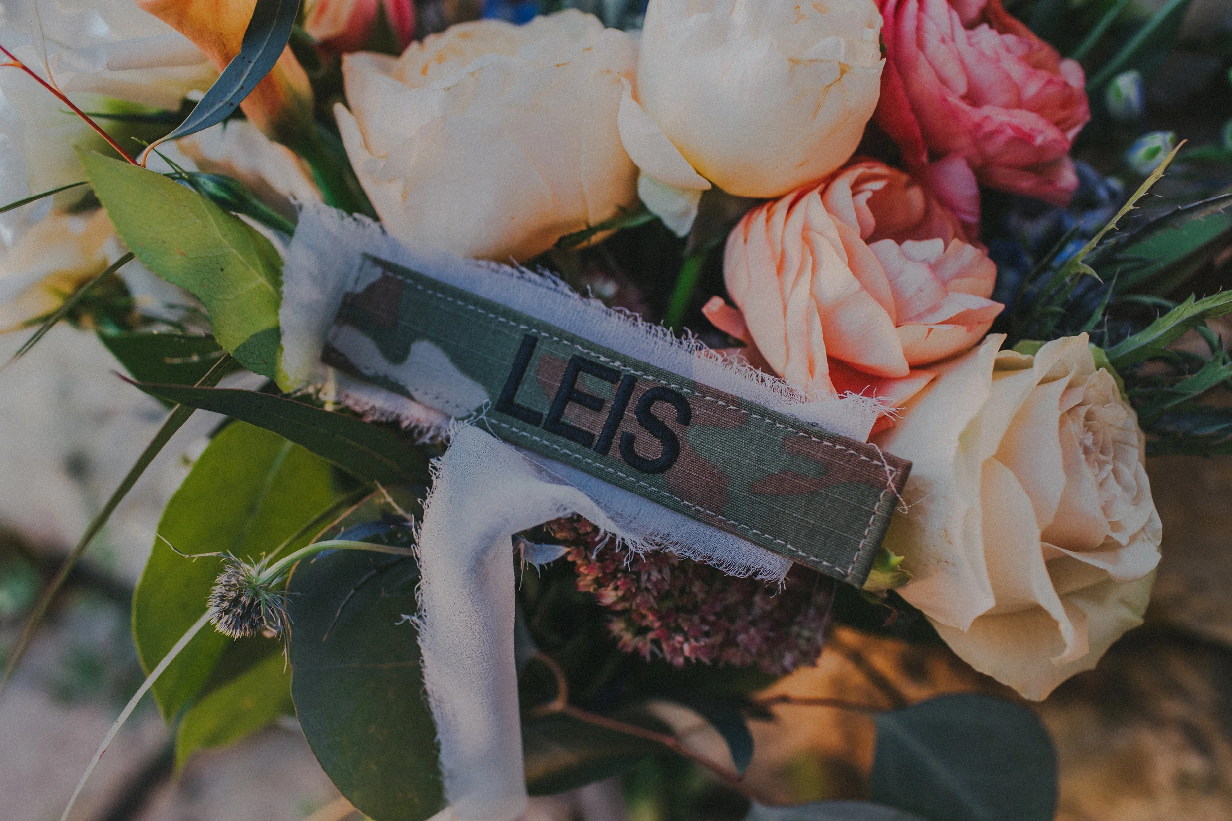 I am a military wife, but instead of have a red-white-and-blue wedding or making my groom wear his dress blues and melt in the hot sun, I opted to have military details mixed in through-out the festivities. I had his nametap Velcroed onto a ribbon I had tied around my bouquet. Also, instead of doing the usual “dollar dance” we did a donation dance where we raised money for a local veterans charity. I had planned on the flower girls using Kyles ACU caps as flower baskets, but I wasn’t going to argue with 2 year olds so they opted to be walked down the aisle by the ring bearer instead.