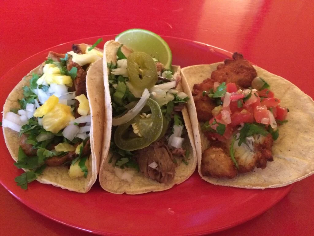 from left to right: al pastor, barbacoa and pescado tacos, some of the kitchen's best
