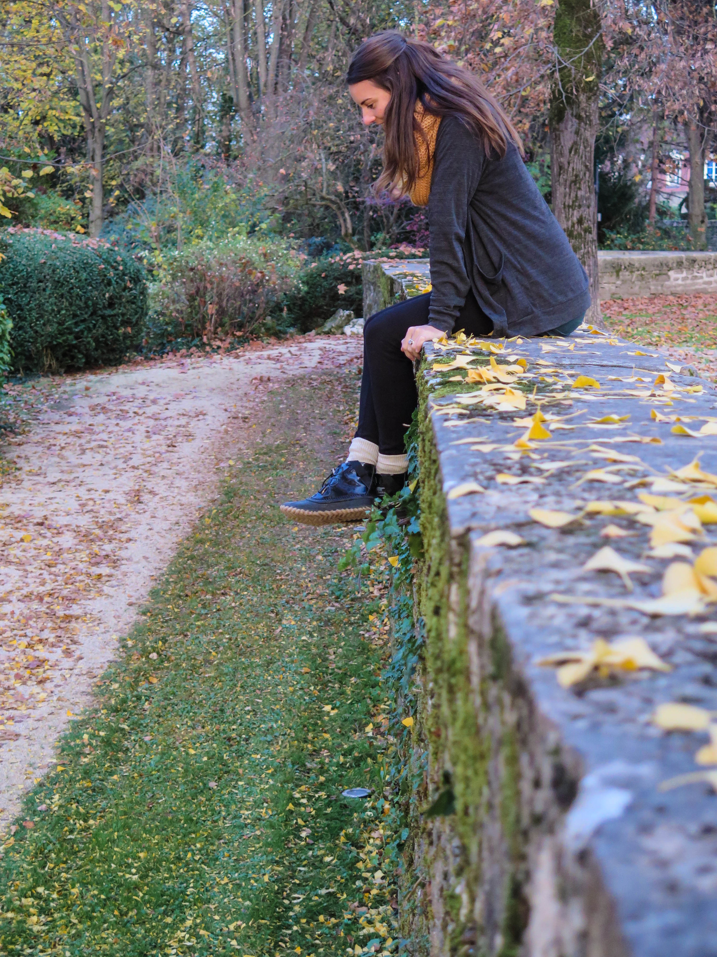 Ang hanging over the side of the wall.