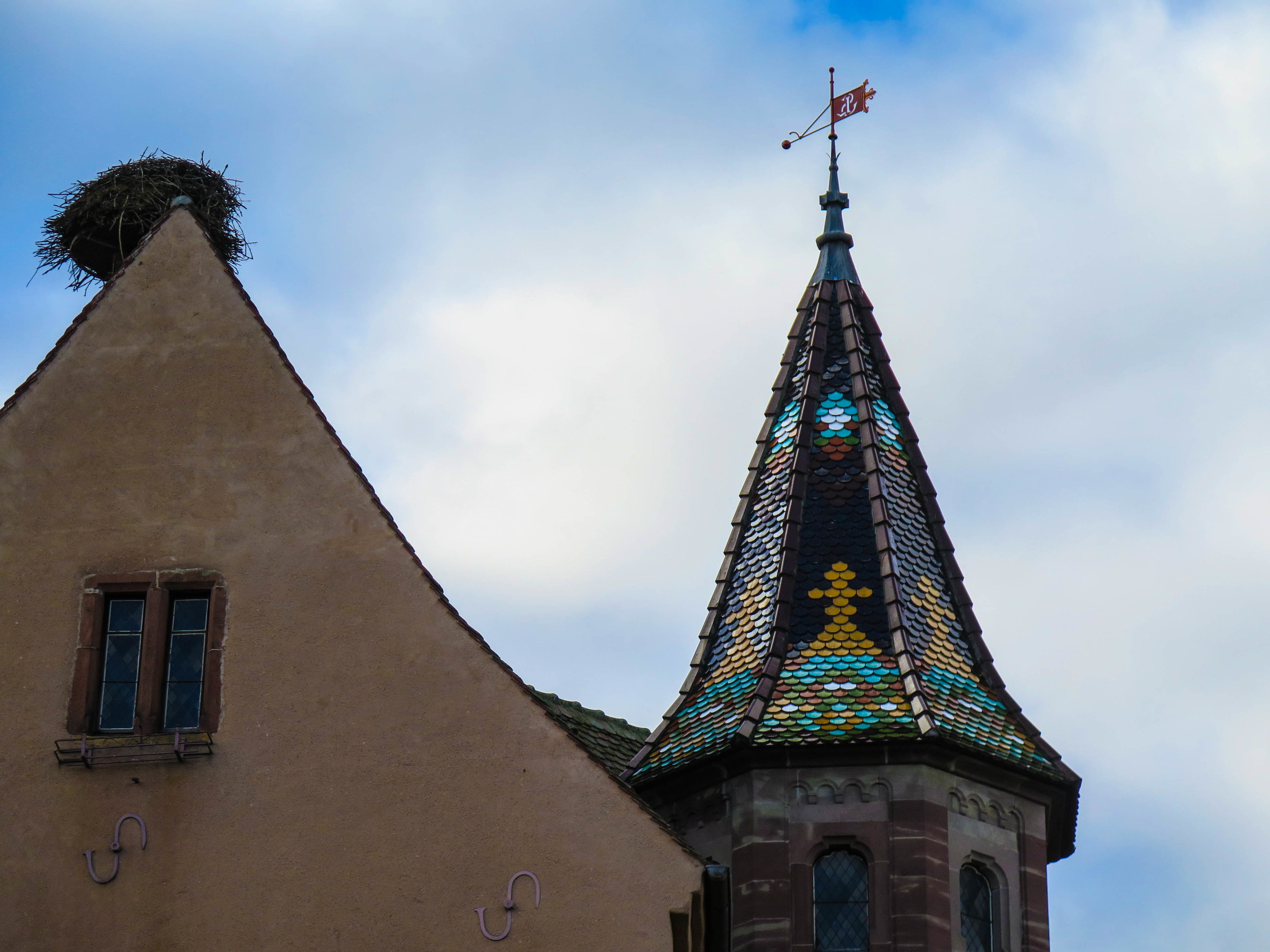 A huge stork's nest on top of the church.