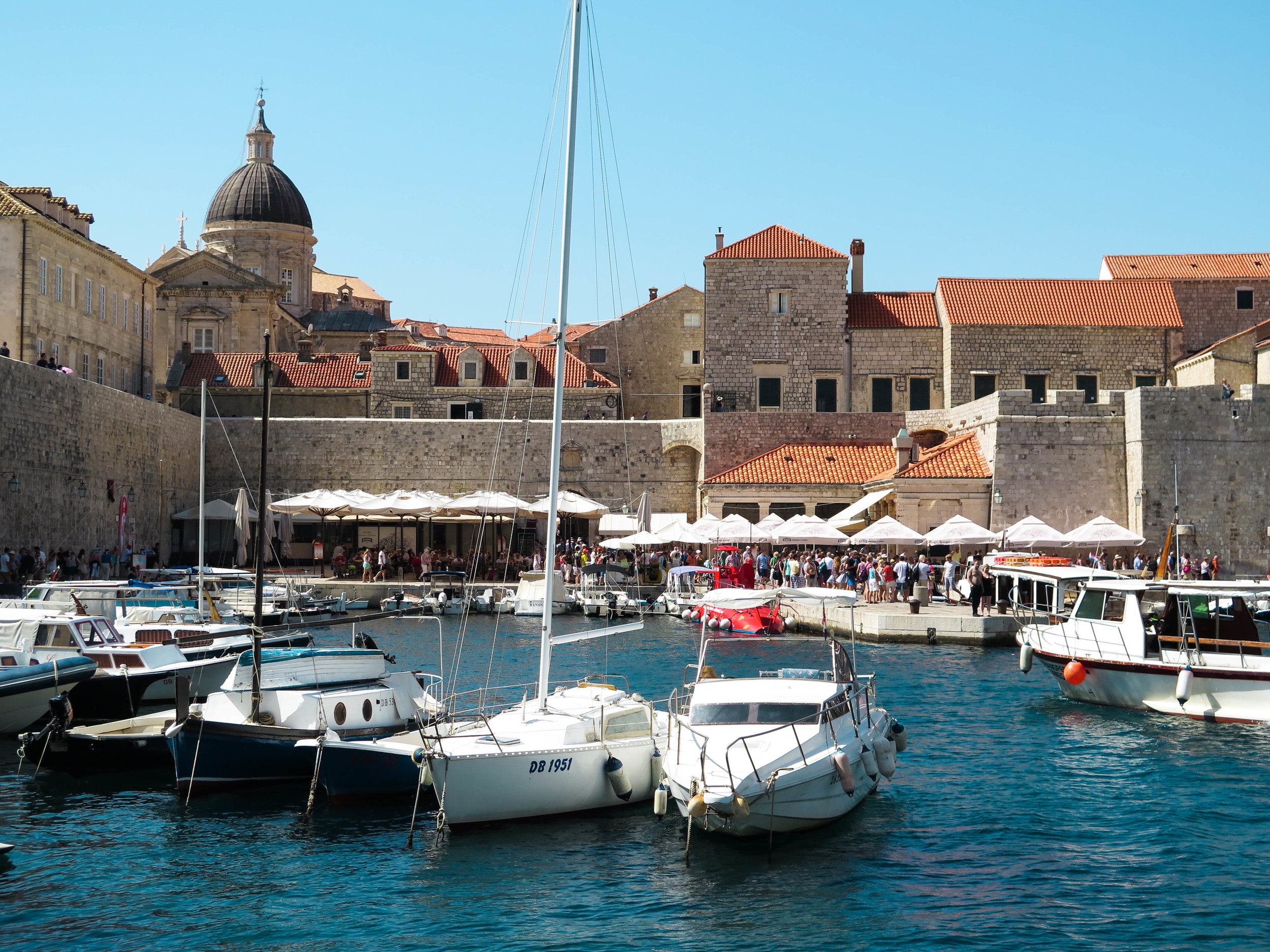 The white umbrellas of Restaurant Lokanda in the old harbor.