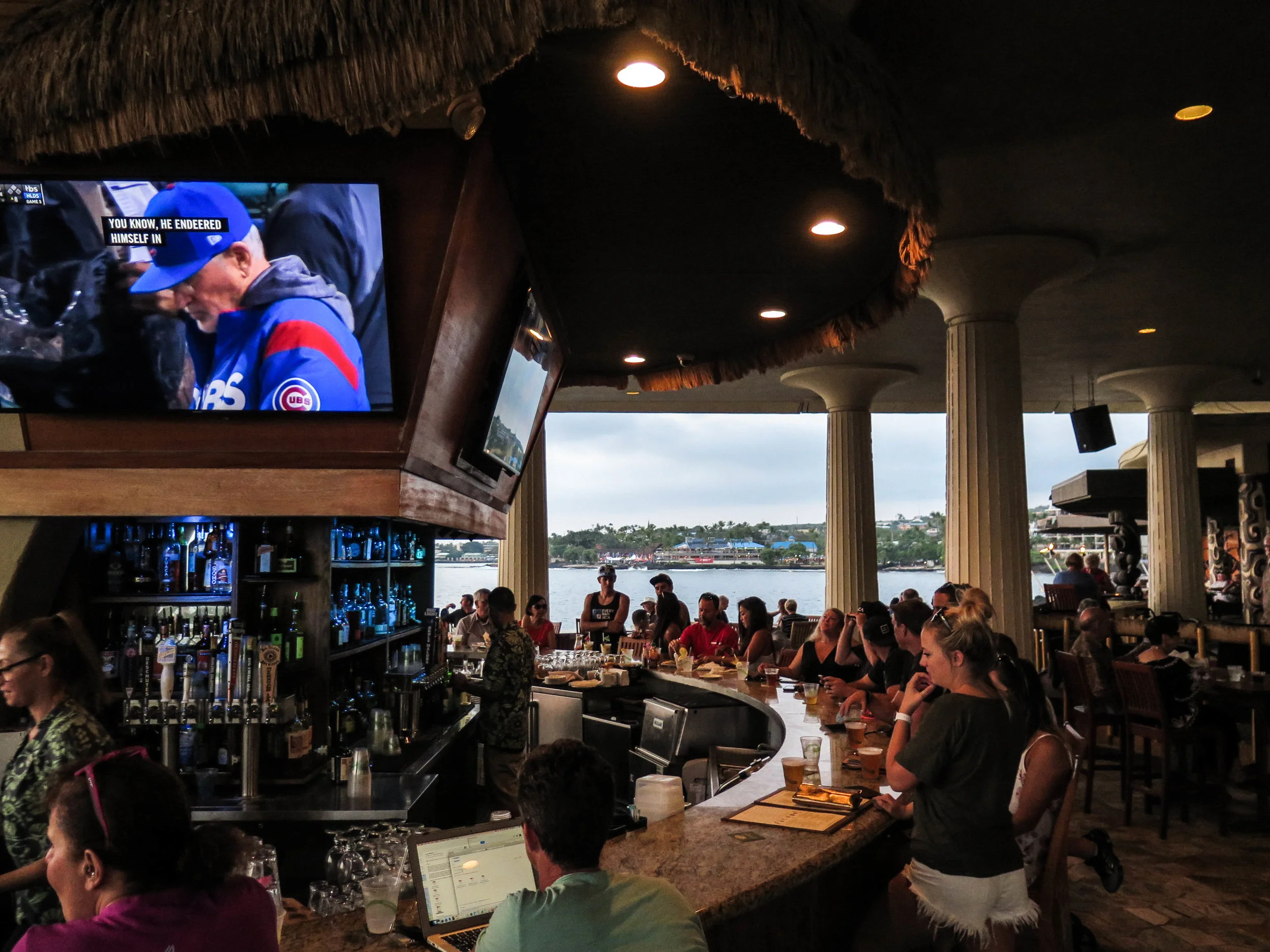 Large HD tvs at the bar with views of the ocean