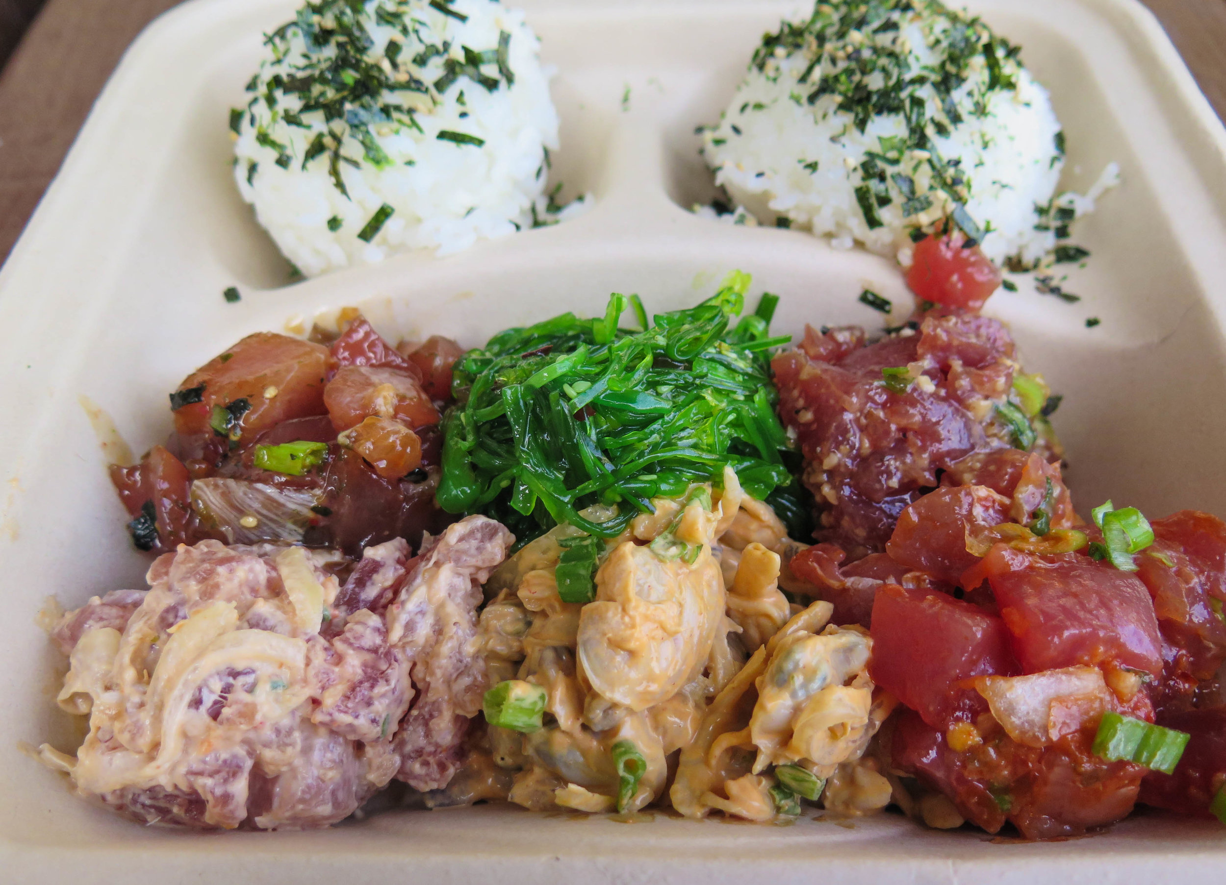 Our bowl! With 4 different scoops of ahi poke, seaweed salad and spicy clams.