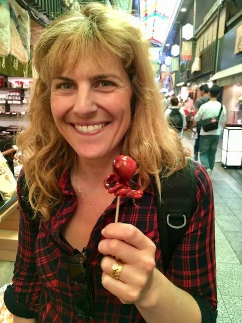 Tiny octopus with an egg yolk stuffed in his head at Nishiki Market