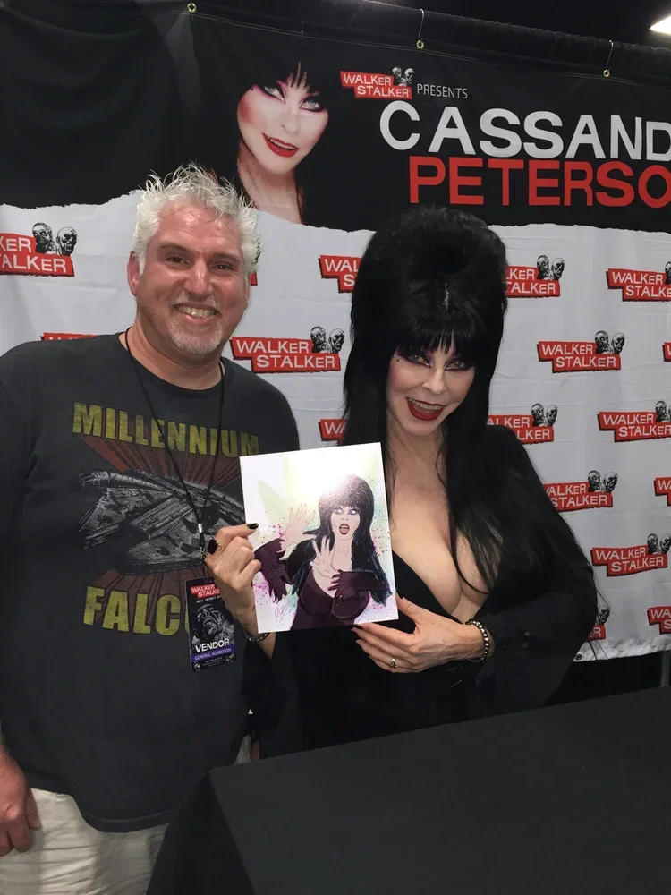 Artist+Mike+Brennan+and+Elvira+Mistress+of+the+Dark+Cassandra+Peterson+.webp