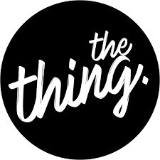 Black circle with white handwritten text saying 'the thing.'