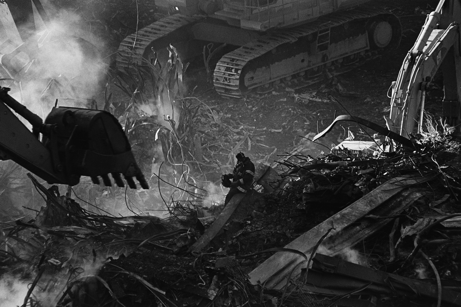   Firefighter in the rubble of Ground Zero  New York, NY. &nbsp;2001 