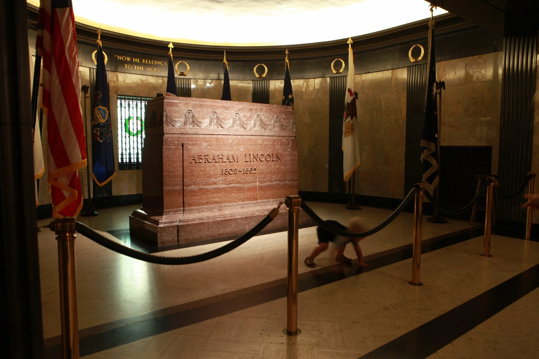 A two-year-old boy plays in a roped off area inside the Lincoln Tomb Oak Ridge Cemetery Springfield, IL. 2014