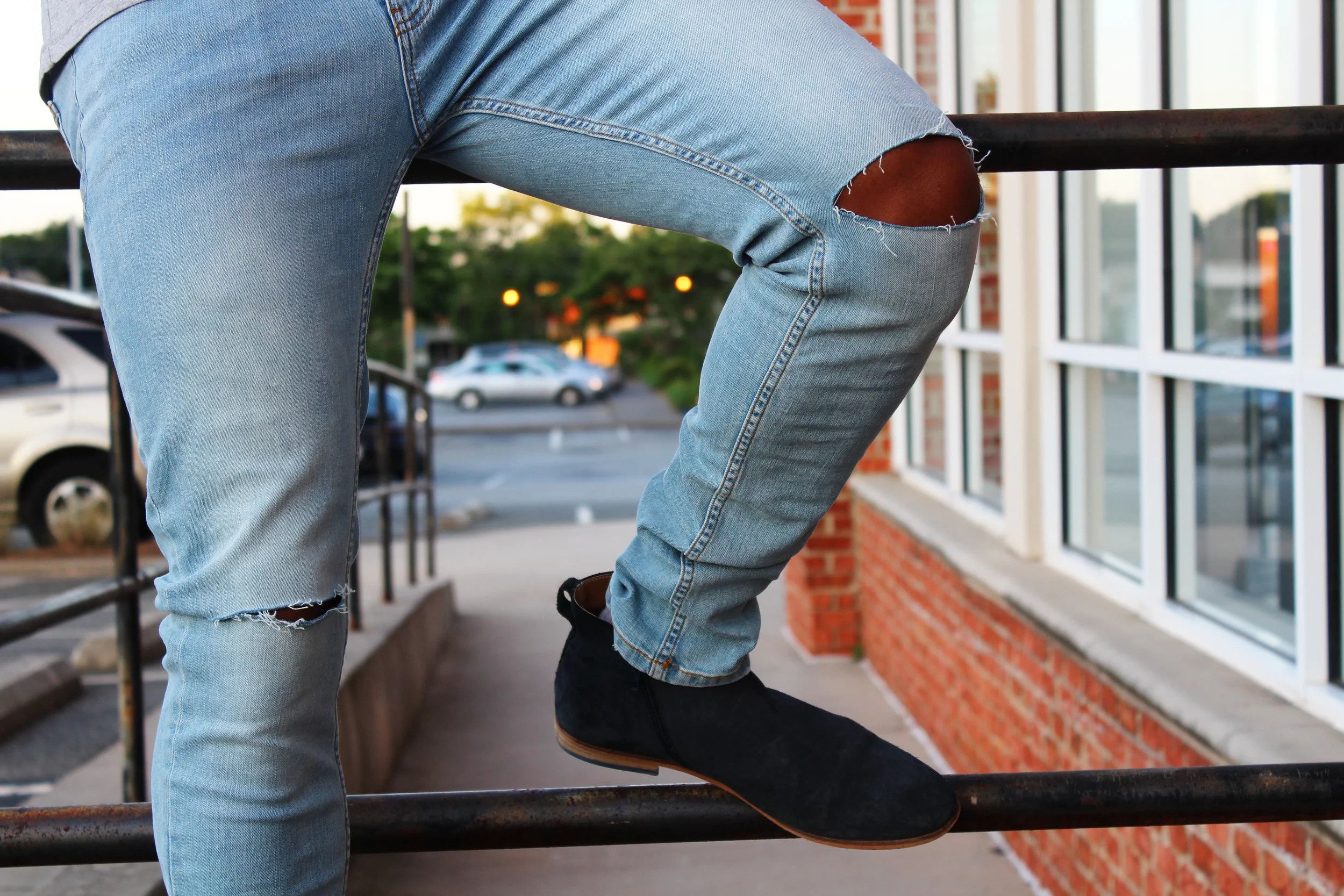 Ripped jeans are most effective with looks that you wouldn't wear on a date or when you want to make a first impression as a law-abiding citizen. Opt for chelsea boots that stack at the ankle for a streamline look, and invest in a few basic tees for the long summer ahead. In this look, I'm wearing jeans from Forever21 with stretch-fabric technology that allows for comfort and breathability. Hey, those are the first two things you want when only your knees and arms and breathing in an outfit. DJ Hargrave is a menswear blogger and founder of Tailor Made Style. HIs goal is to empower others to become the strongest version of themselves through their style and helping them be informed by what's going on in the menswear world. You can find him on Instagram and Snapchat @tailormadedj