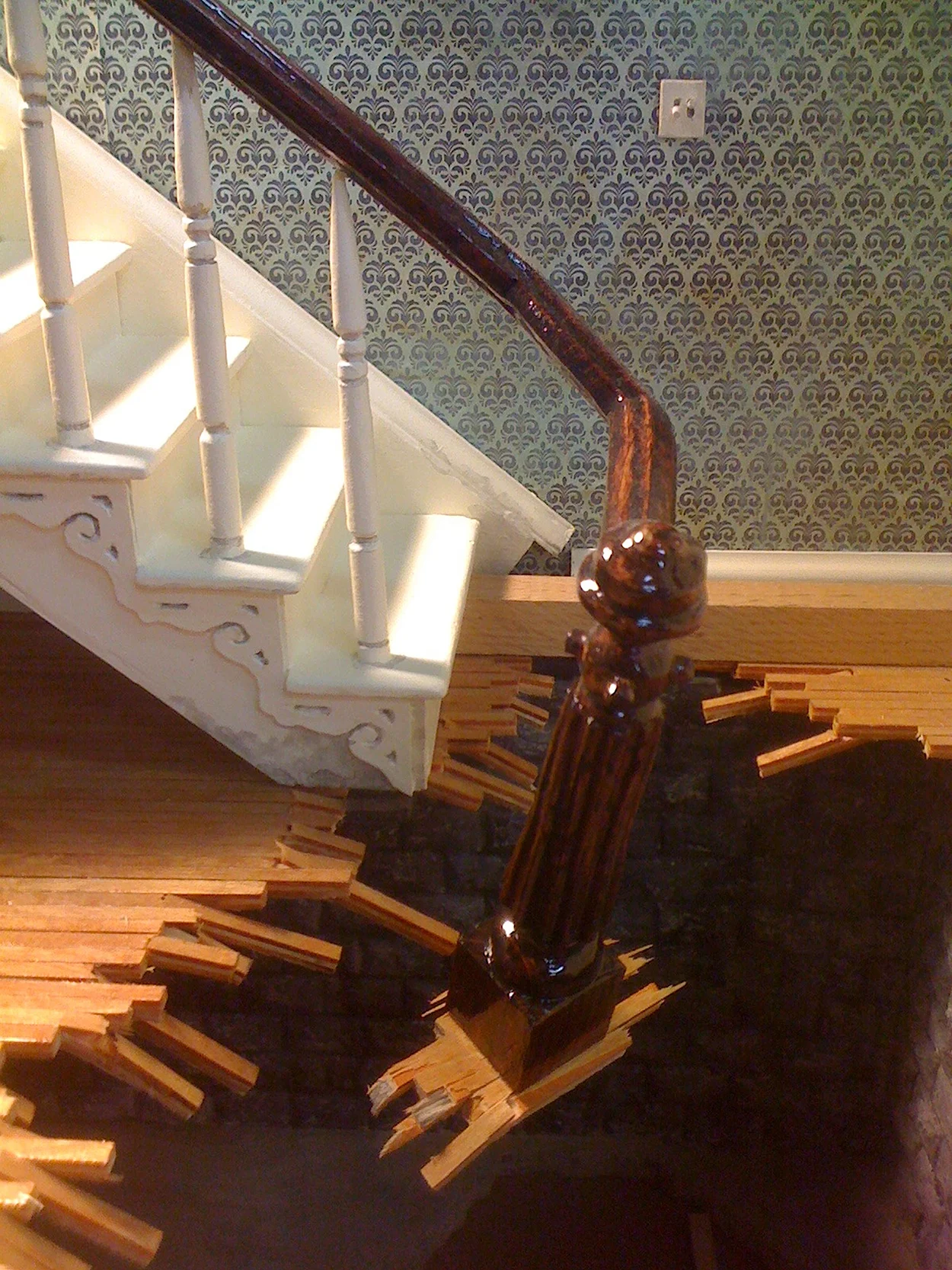 'Tom Ridge' Stair Newel Post / Sinkhole Detail Wood framing, Metal mesh, Mahoghany Handrail, Moving Blankets, Cart, Fiberglas Insulation, Metal Floor Grates, Cast Iron Window Weights, Audio Approx: 18’L x 3’W x 12’H 2014