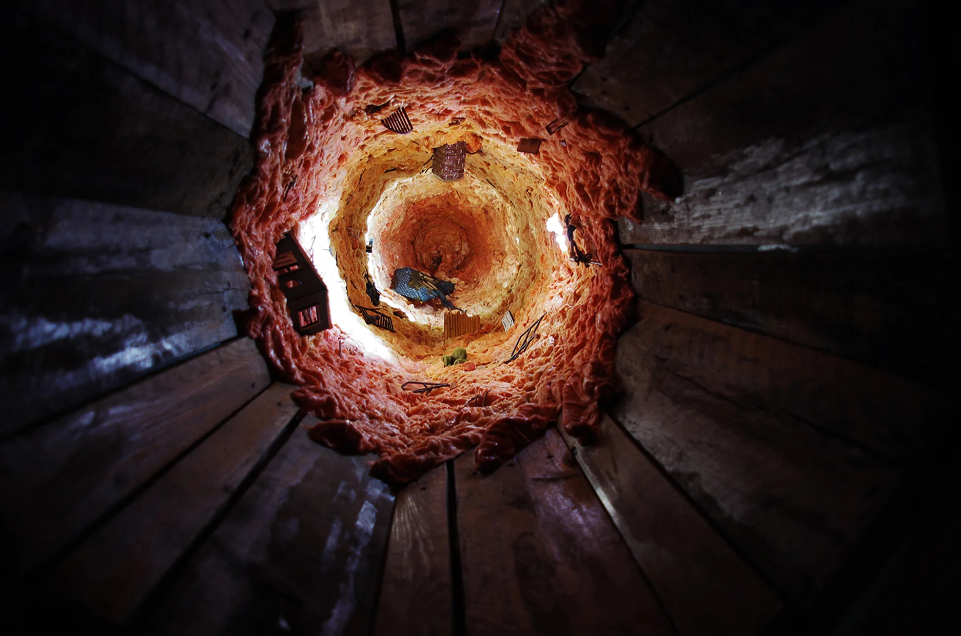 ‘Beneath / Suspicion' Detail at Fleshy Vortex Vignette Wood framing, oak pallet wood, drapery, nightlights, kiln-burned pine tar, incense, muslin. glass view lenses, fiberglas insulation, audio track. Tunnel Portion- 3’W x 2’-8”H x approx. 120’L 2013 Image credits: Gordon Pellegrinetti.