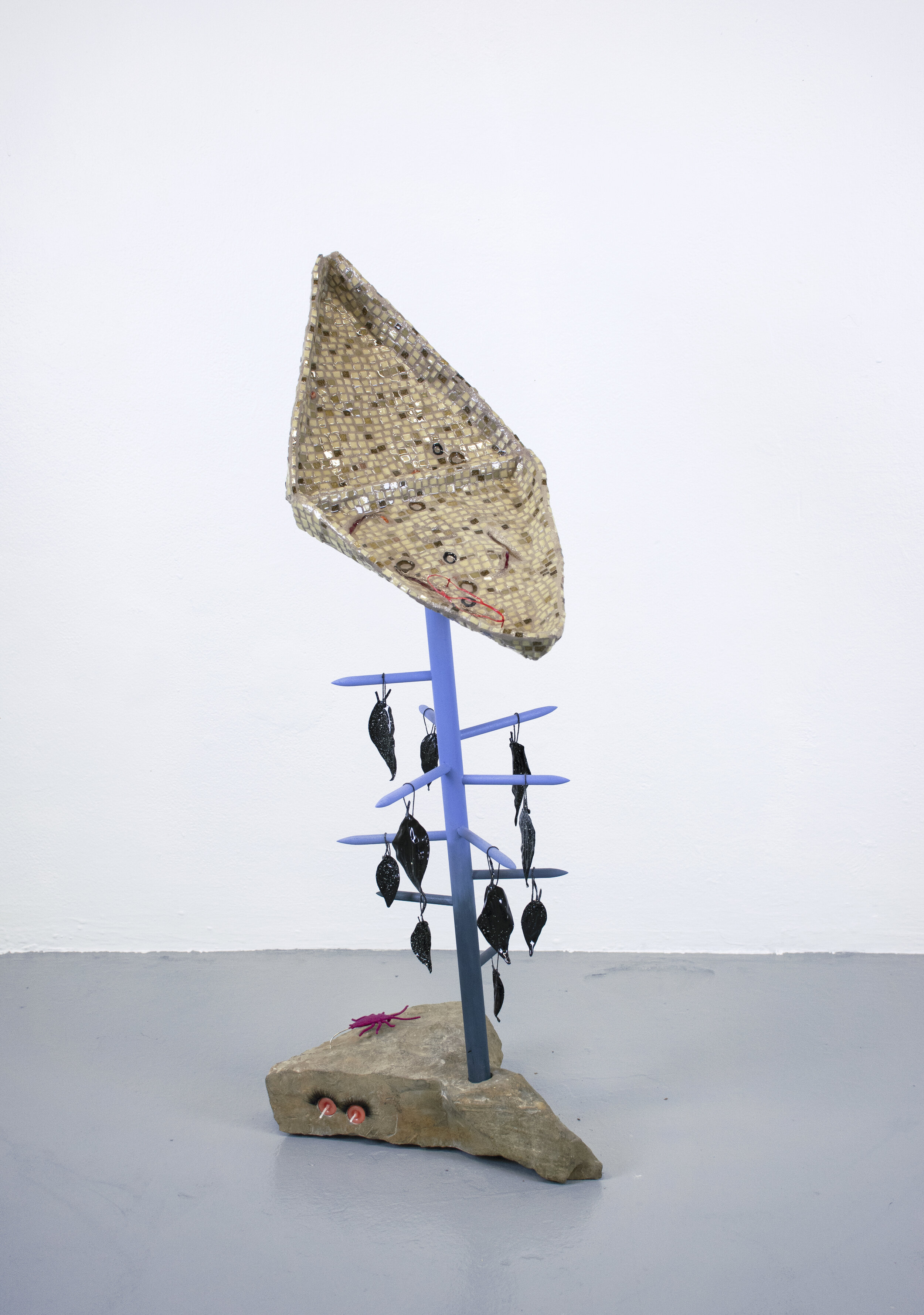   Pizza Tree,  2019. Preserved olives and red onion, gravestone dust, wax, lashes, flock, rock, wood, wire, paint, plastic, mosaic tile, resin, and that string from a Babybel Cheese, 12x18x36”    