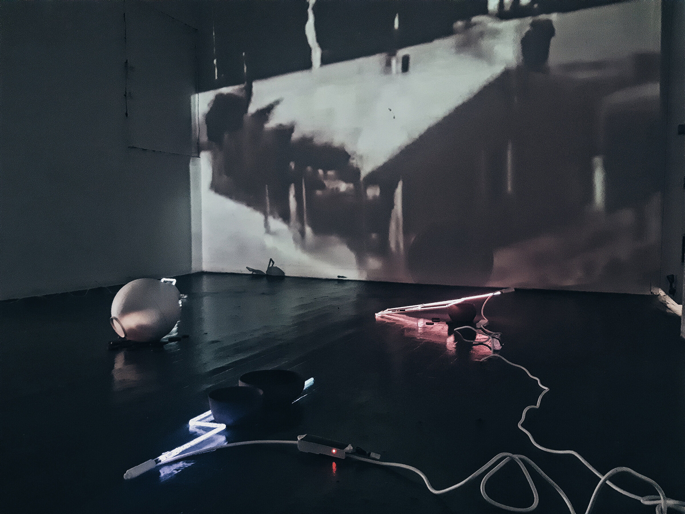 /born ignorant in an abyss of light (installation view), glass, plasma, porcelain, video, 20x30 feet, 2020