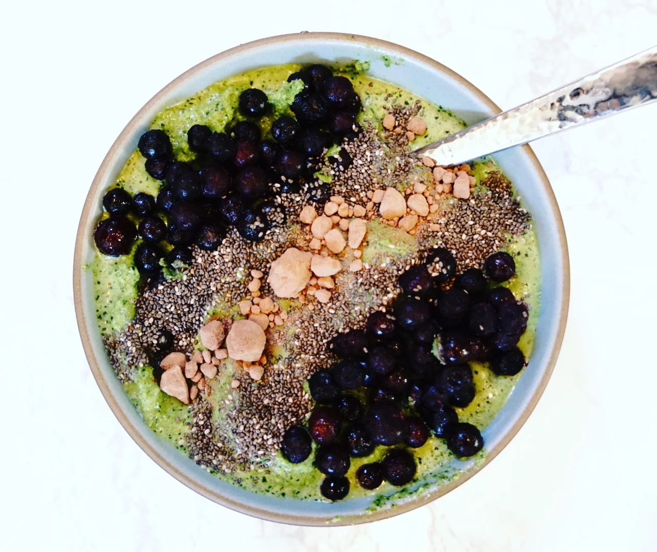 This is the smoothie bowl I've been really into. It's almond milk, kale, vega protein powder, MCT oil and almond butter topped with blueberries, chia and cacao. 