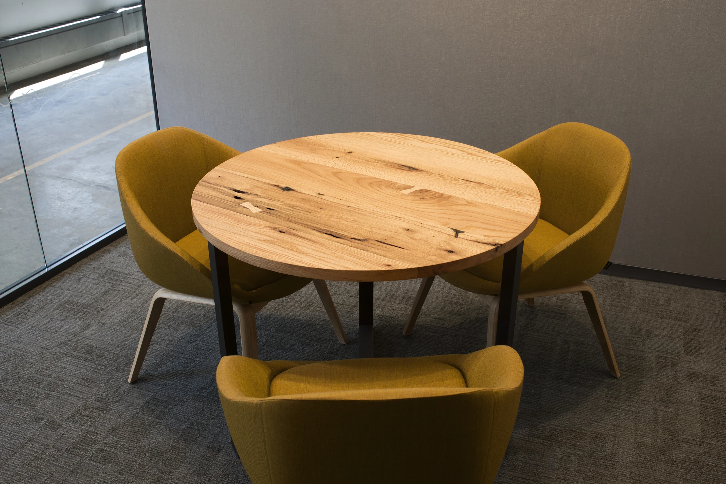 Rather than discard furniture from their old offices, Etsy had us re-use old desktops for several pieces, including these meeting tables in red oak and ebonized walnut.