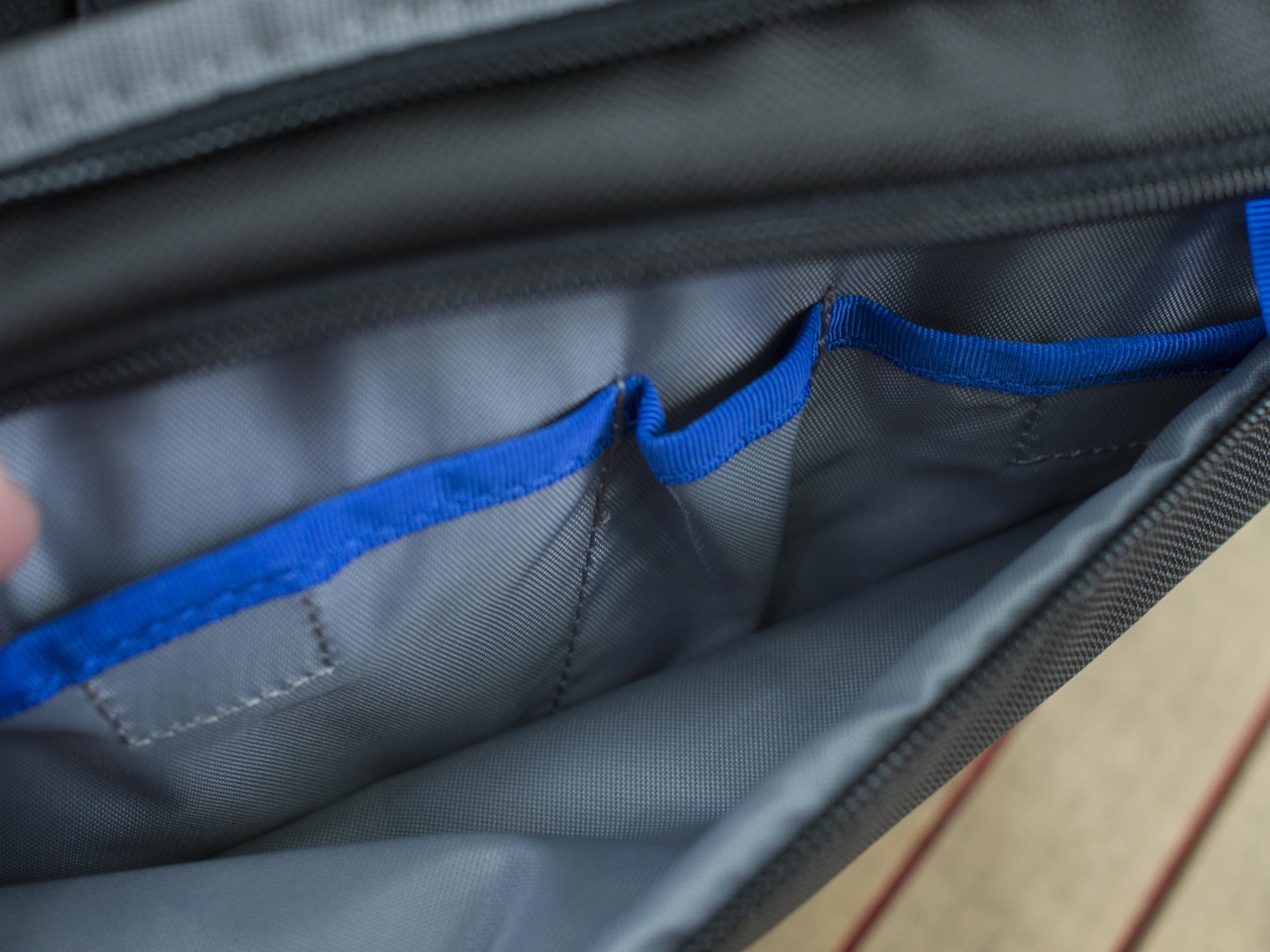 The front pocket will hold several small items like a phone, note pad, pen, map, batteries, cards etc. It is flat, but roomy.