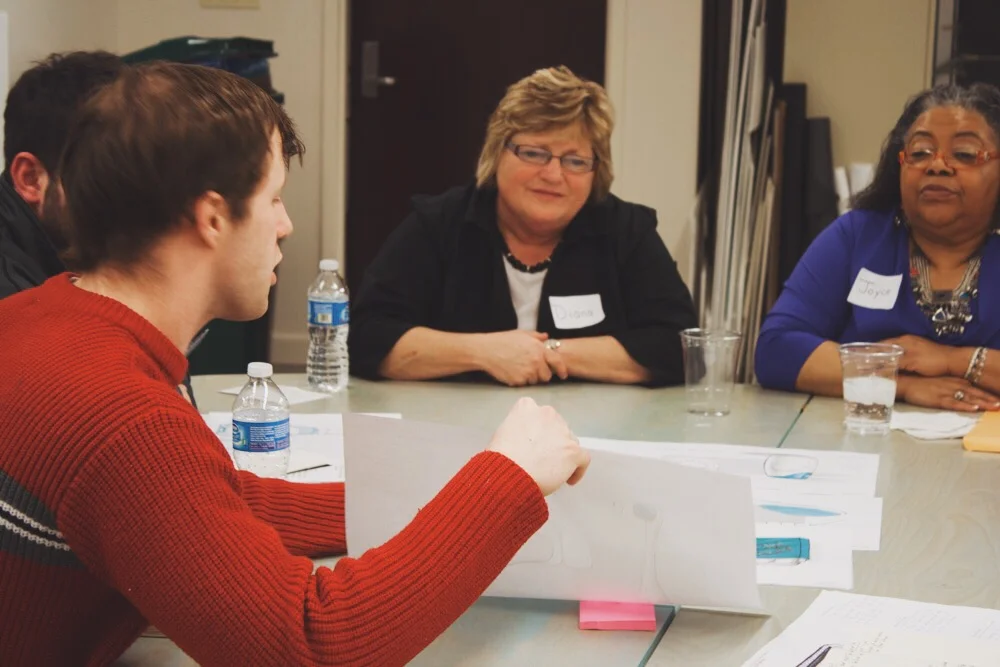 A student presenting a concept during a speed-dating co-creation session with the original cohort of customers.