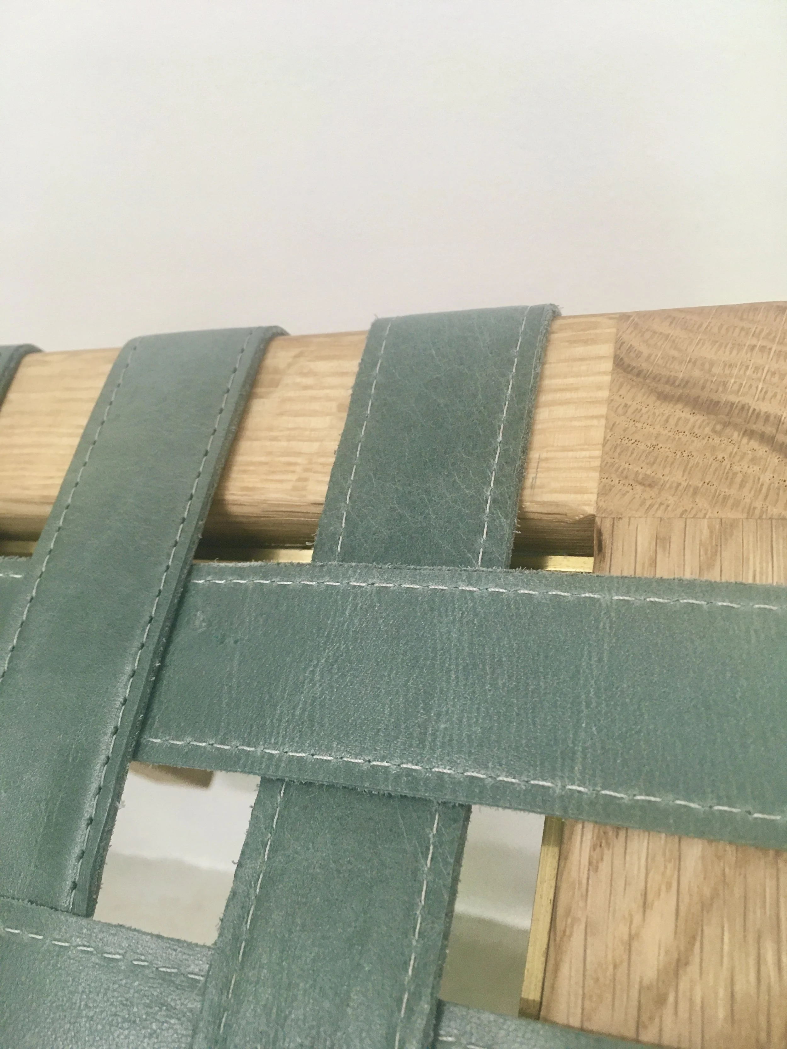 Brass plate replaces traditional tacks.