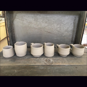  Then handles are made and attached. The mugs are air-dried before going into the kiln for the bisque firing. 