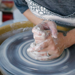 The clay is thrown on the wheel by Mercedes and made into vessels.