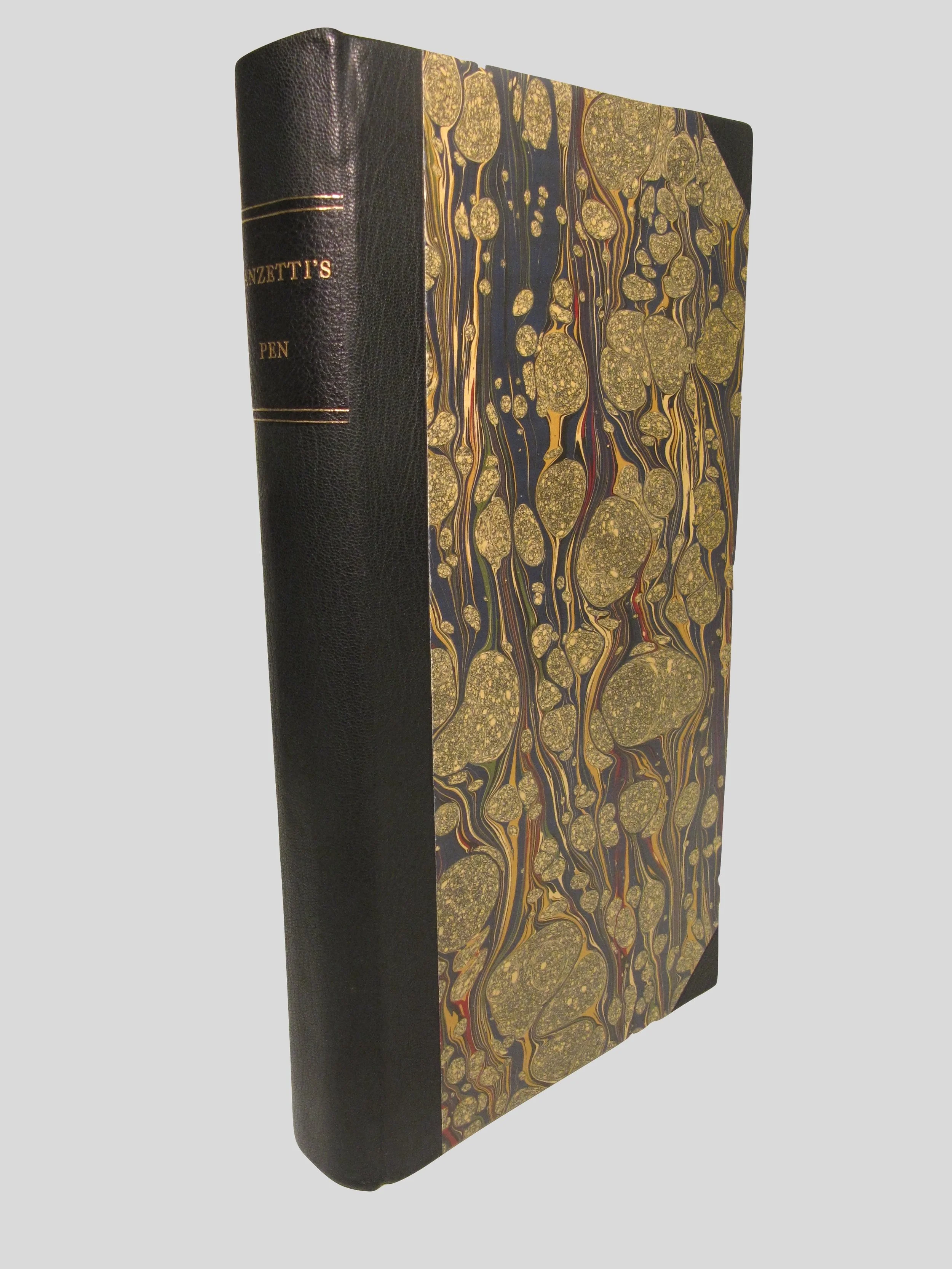 Carved ivory pen. Rounded spine clamshell box in half leather. Title label across spine. 