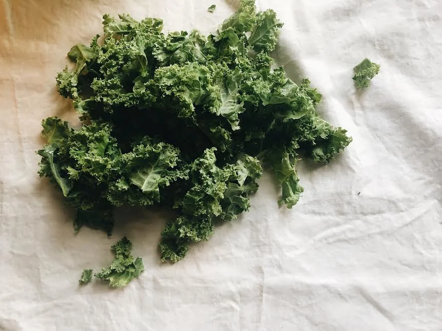 add handful of kale into mixture and cook until wilt