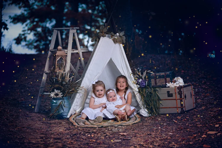 Three sisters photographed together at blue hour