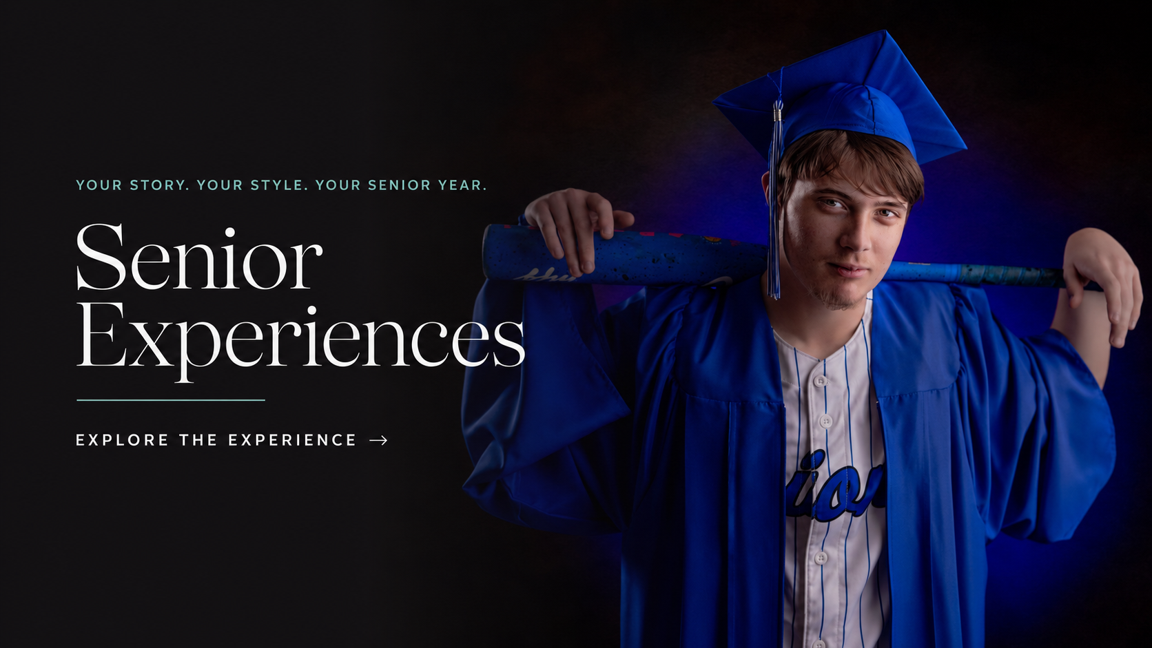 A young man in a blue graduation cap and gown holding a diploma and a decorated staff, posing confidently against a dark background, celebrating his senior year.