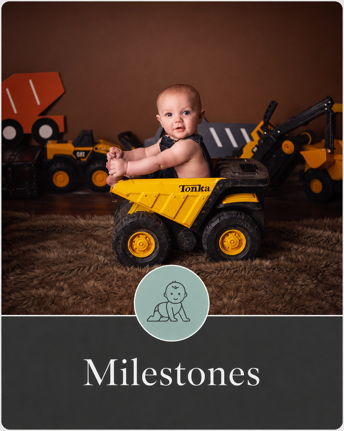 A baby sitting inside a yellow Tonka dump truck toy, surrounded by construction-themed toys in the background, on a furry rug. The image is part of a milestone photo series.