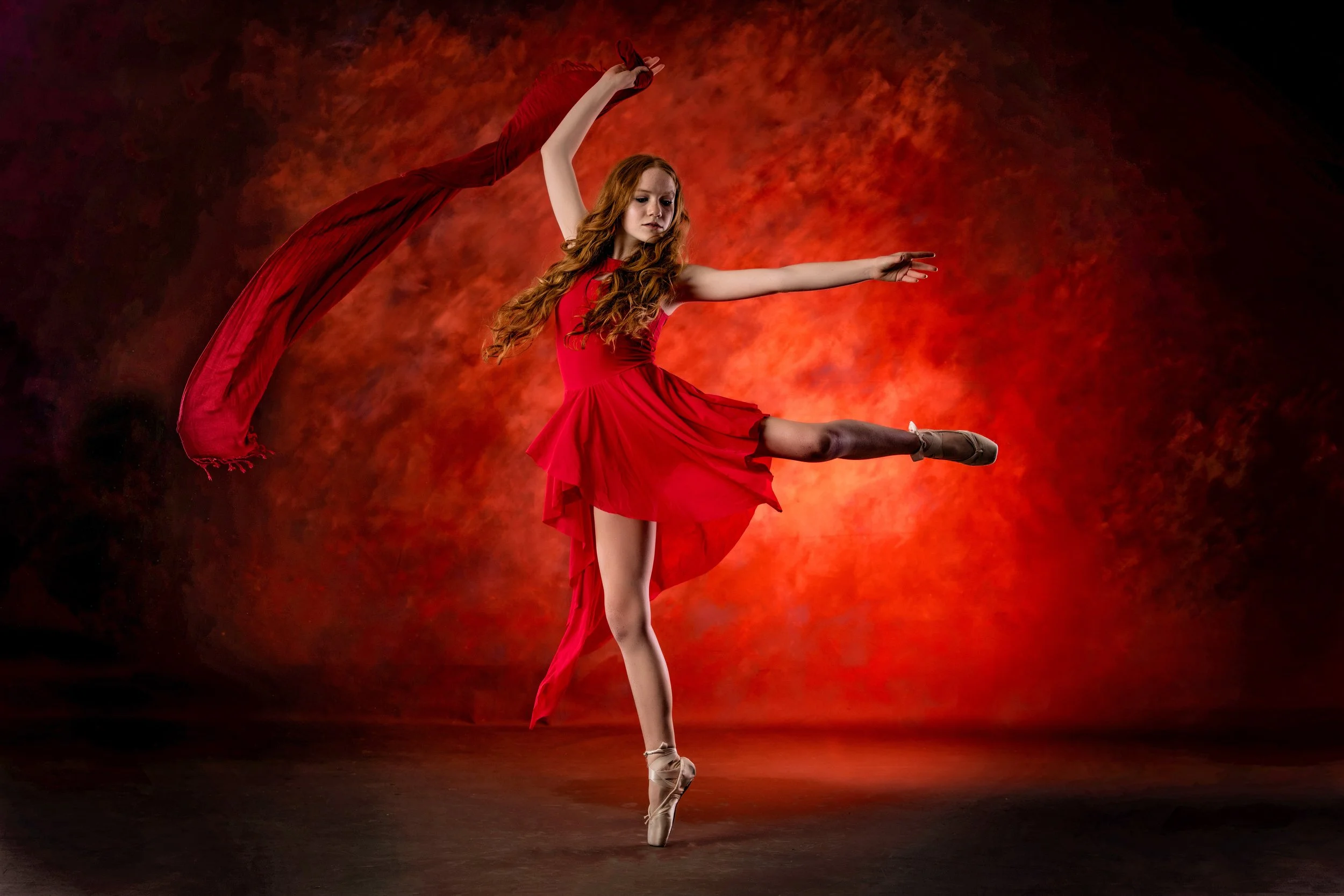 Dancer performing a powerful red movement portrait photographed by Matt and Shea Photography