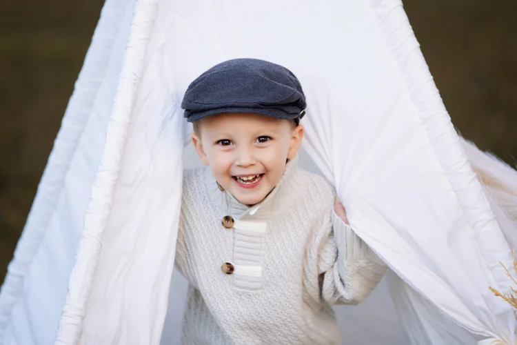 Smiling child peeking through the Twilight tent