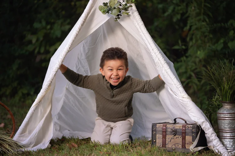 Child playfully emerging from the Twilight tent