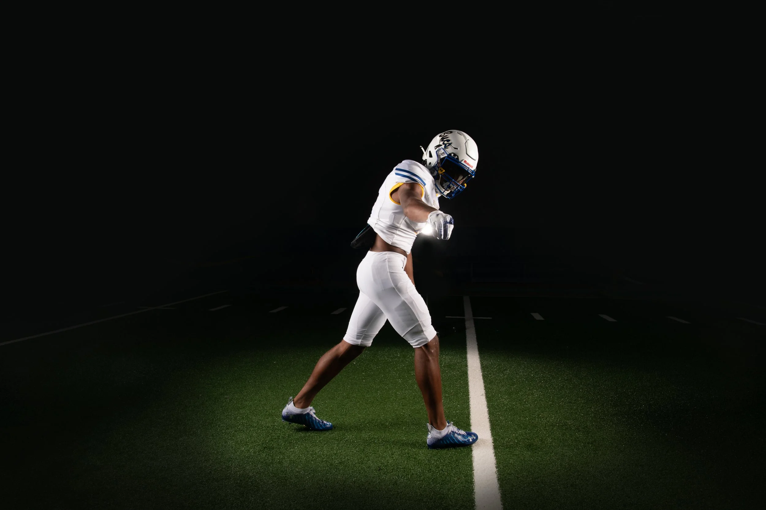 Chattanooga football athlete walking through dramatic media-day lighting