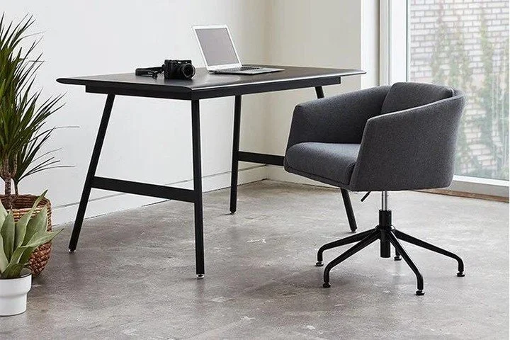 With an elegantly upholstered tub-style form, the task chair is office furniture that captivates with its casual sophistication. Centering a stylish aesthetic and welcoming feel, this chair makes no sacrifices in function: adjustable height, swivel a
