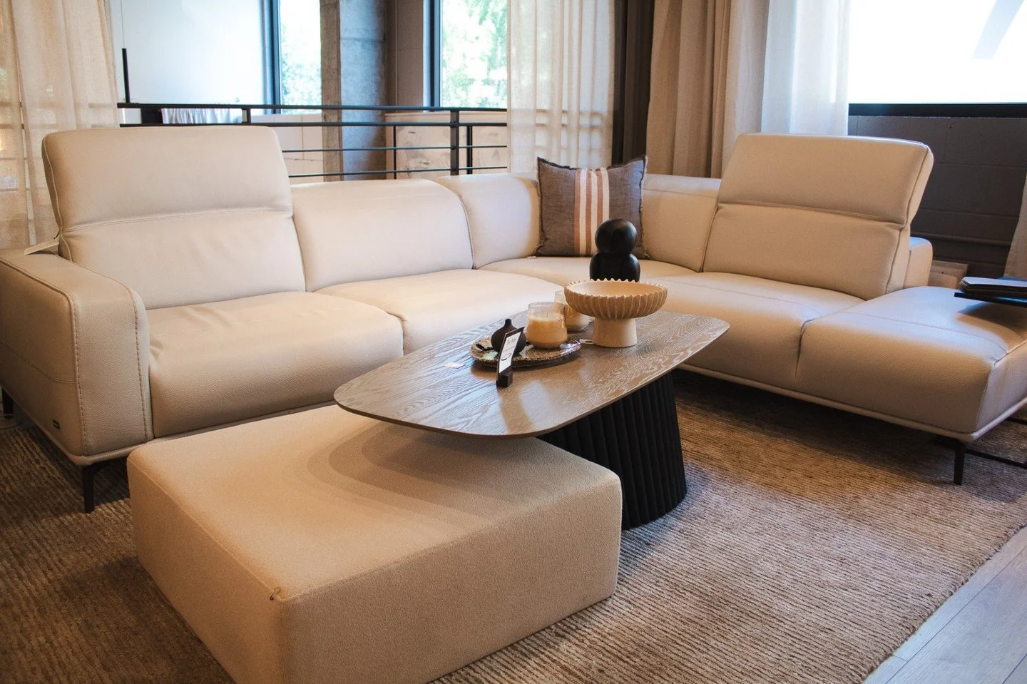 On display in our showroom, this beautifully designed sofa blends clean, modern lines with exceptional comfort. Adjustable headrests let you customize your seating experience, while a wide range of configurations makes it easy to find the perfect fit