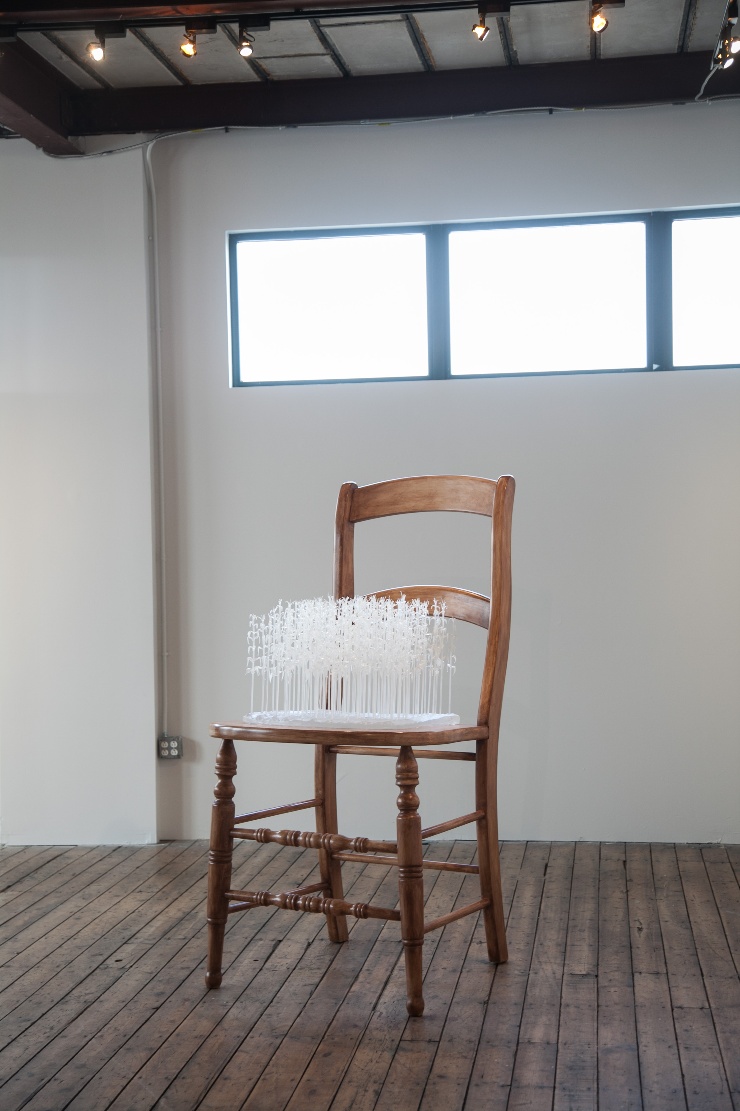 Modified Consumption” 2014, lampworked glass, cast glass, poplar chair, 66” x 32” x 32” Photographer: Lisa Barker