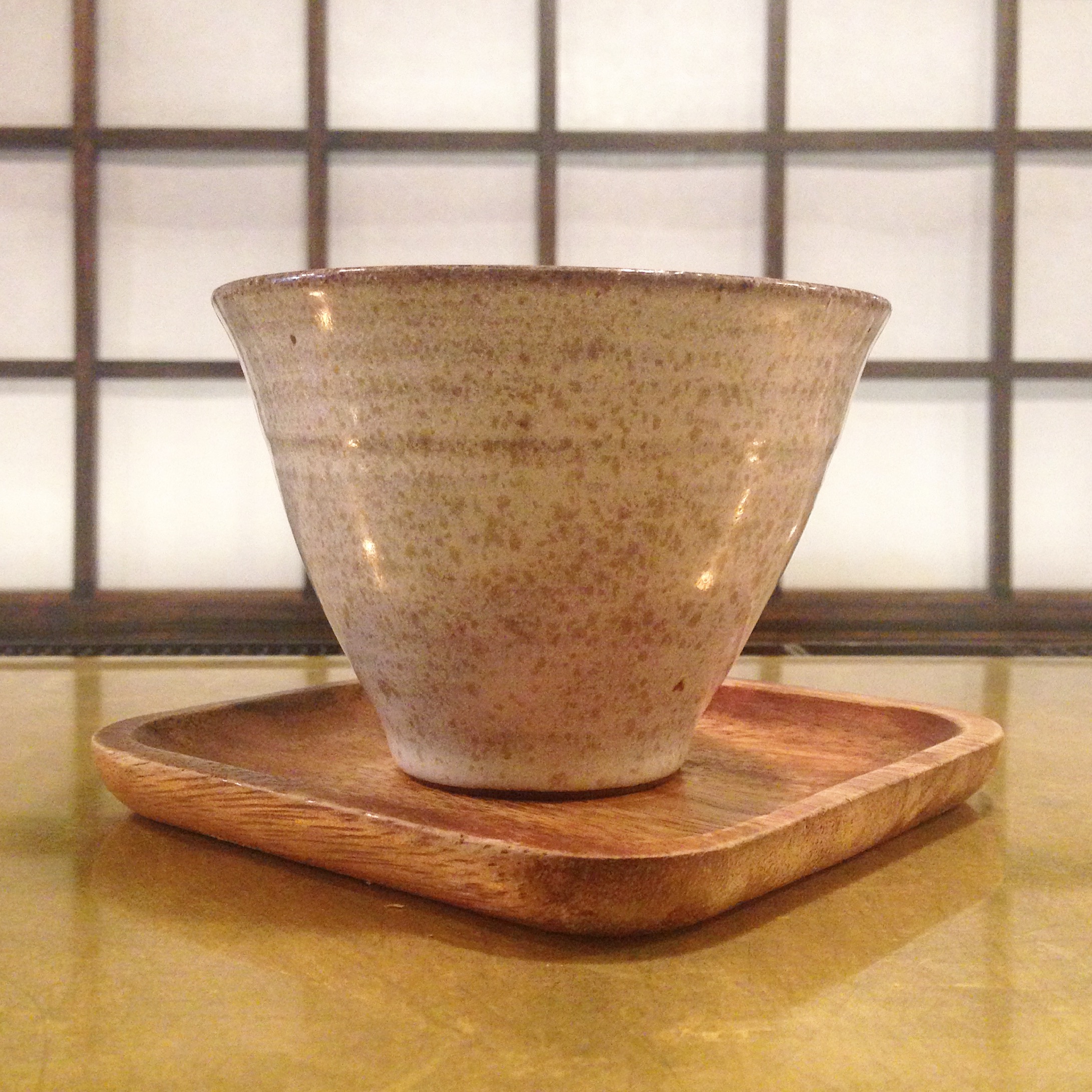 There is coffee inside that fancy cup. It does more than just look nice: the thick base lets you drink while the coffee is hot, the thin rim is delicate and lets you take in all the flavors, and the wide top allows the coffee to cool and gives ample space for aroma. Picture c/o skwon