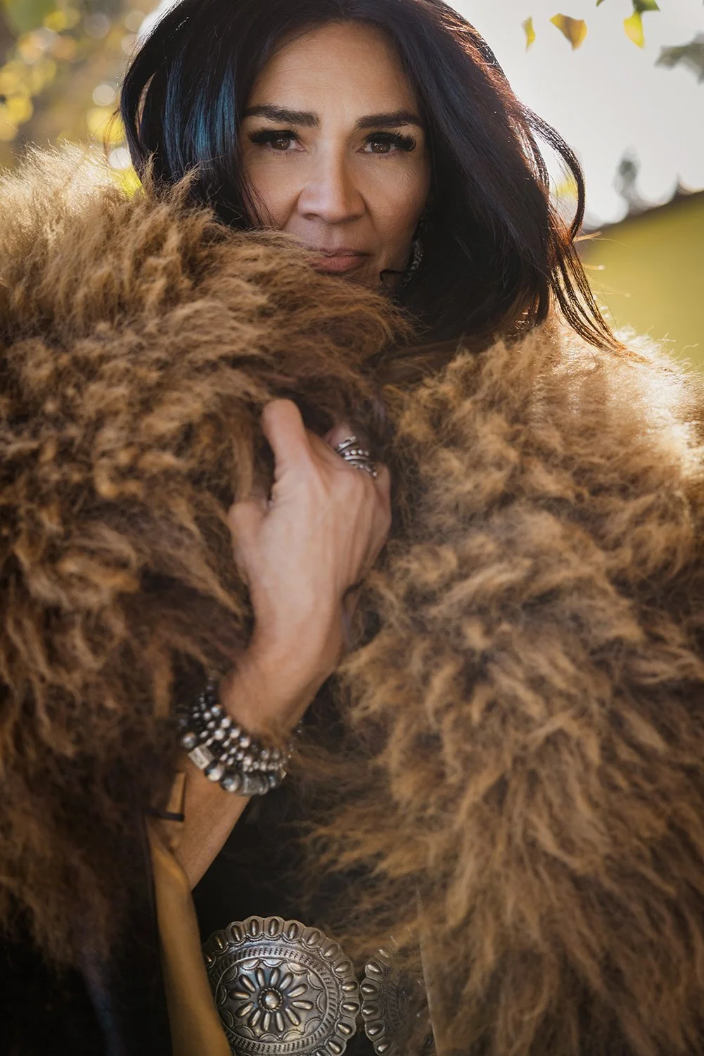 Branding portrait for Indigenous fashion designer Risa Fritz in Longview, Alberta by Dana Pugh Photography. She is wearing her famous buffalo coat. 