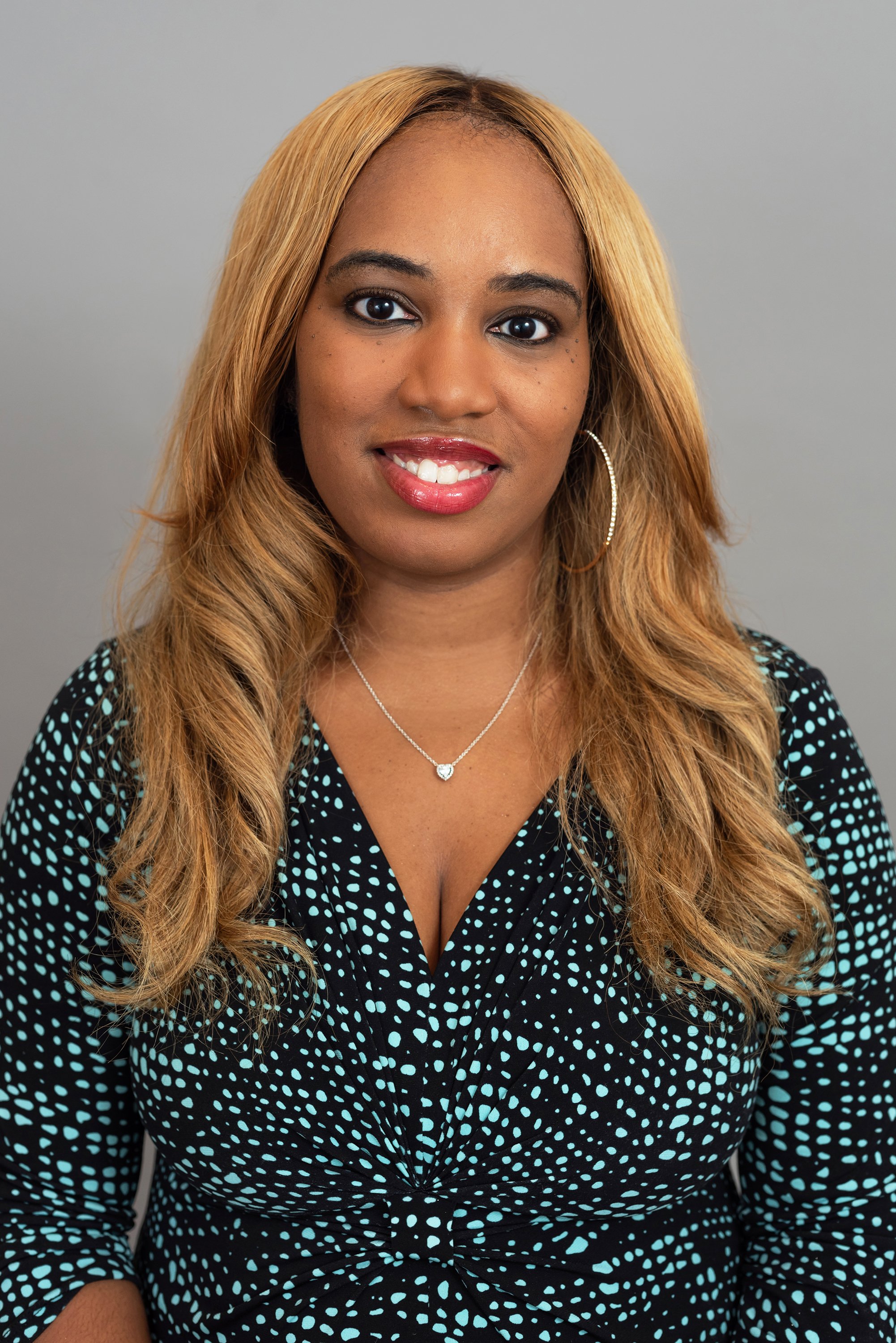  Corporate headshot of woman in black and green top by Ari Scott, NYC headshot photographer. 