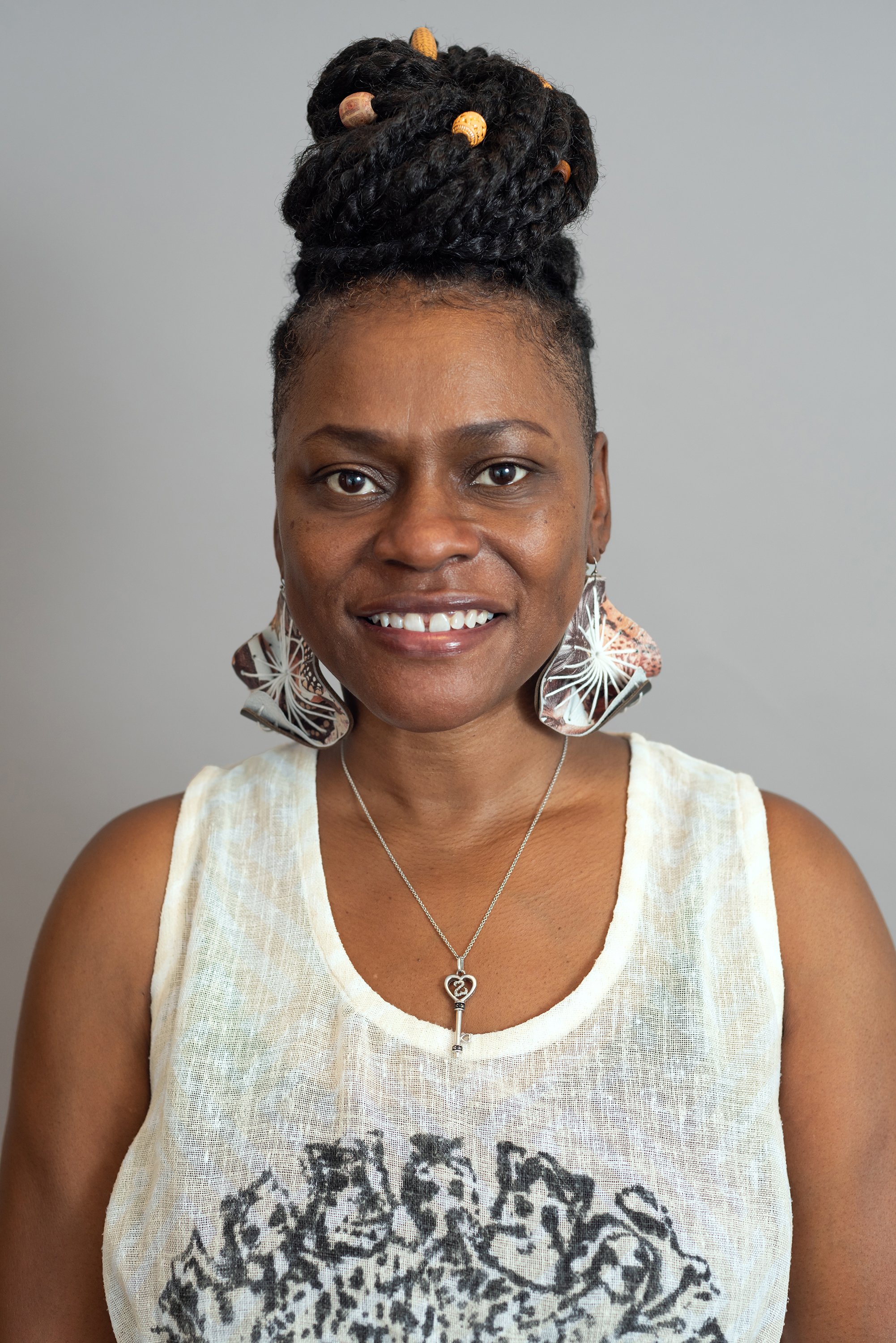  Corporate headshot of woman in white sleeveless shirt by Ari Scott, NYC headshot photographer. 