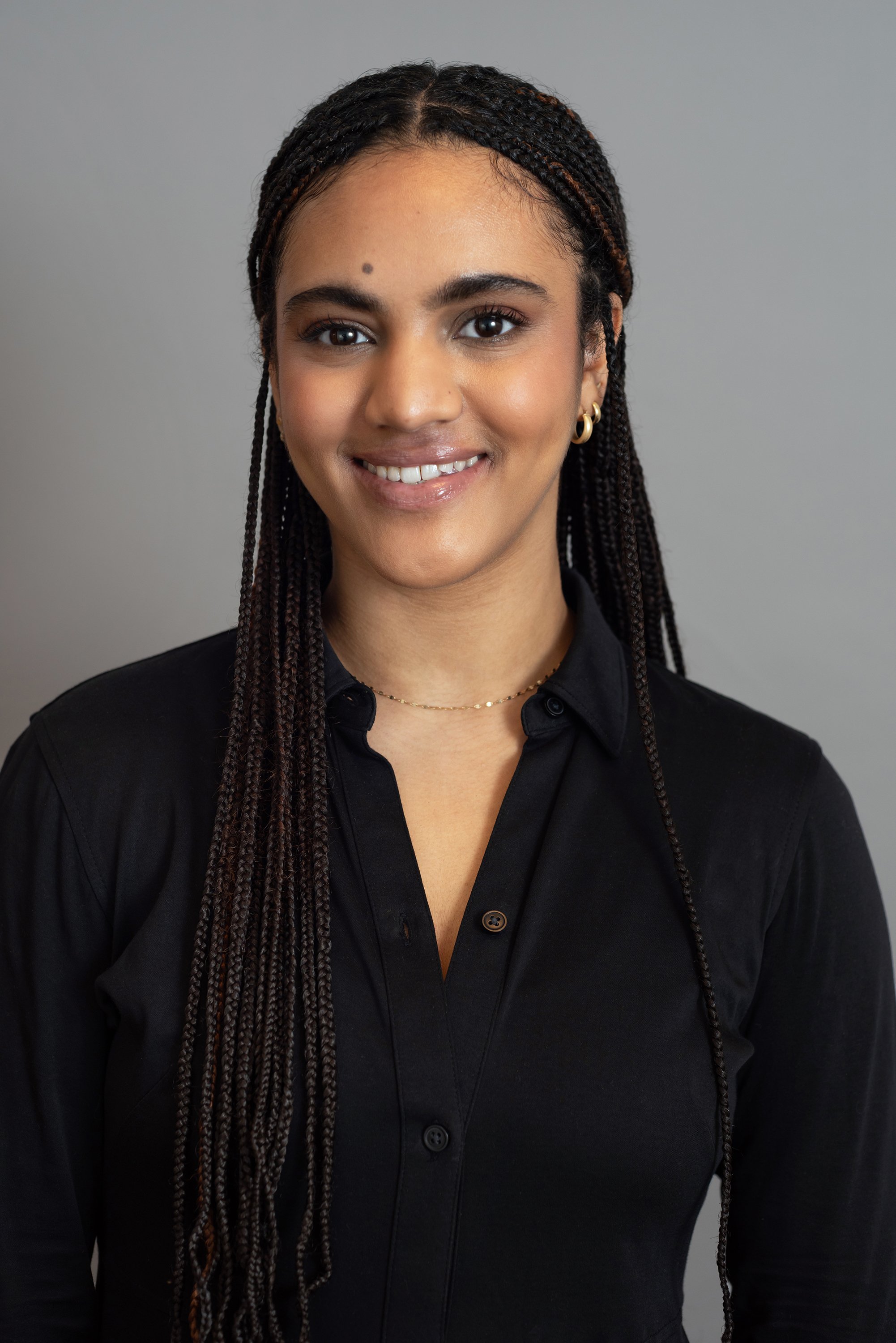  Corporate headshot of woman in a button down black top by Ari Scott, NYC headshot photographer. 